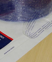 Fiber reinforced finger lift tape on a postal envelope