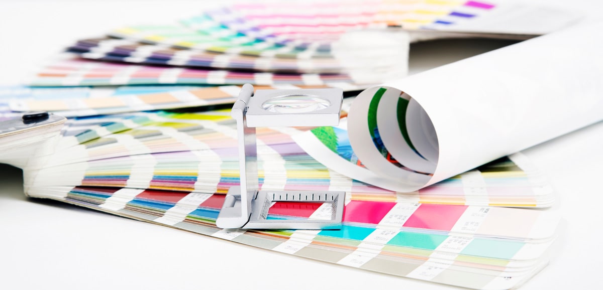 Pantone color books on table with a printer’s loop